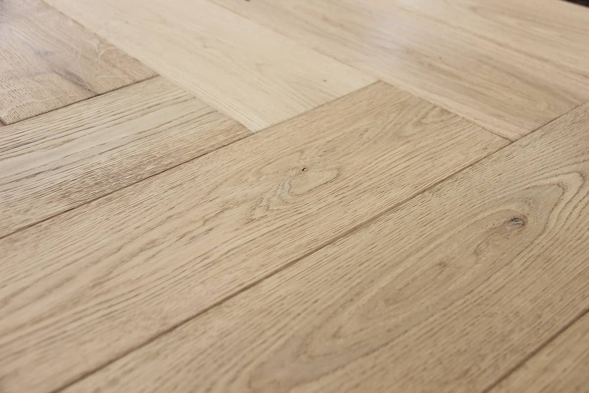 Close-up of oak herringbone parquet flooring pattern
