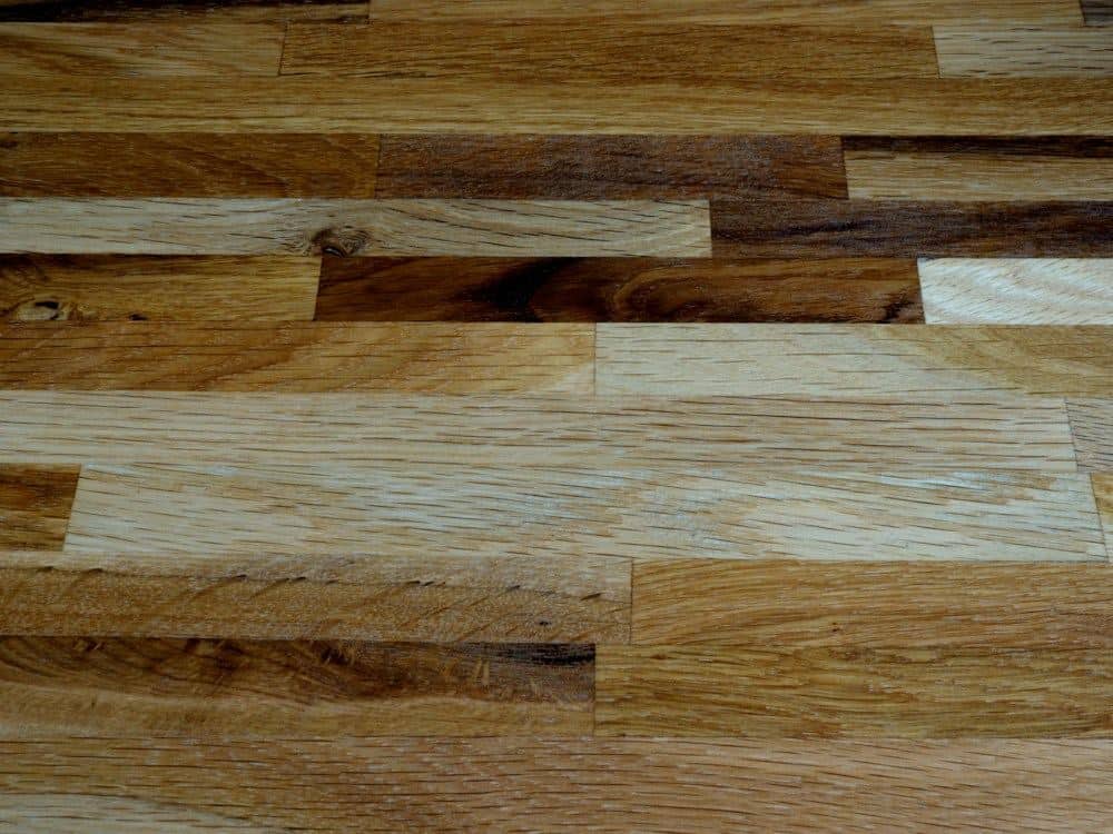 Close-up of hardwood planks with strong light-to-dark color variation, typical of hickory